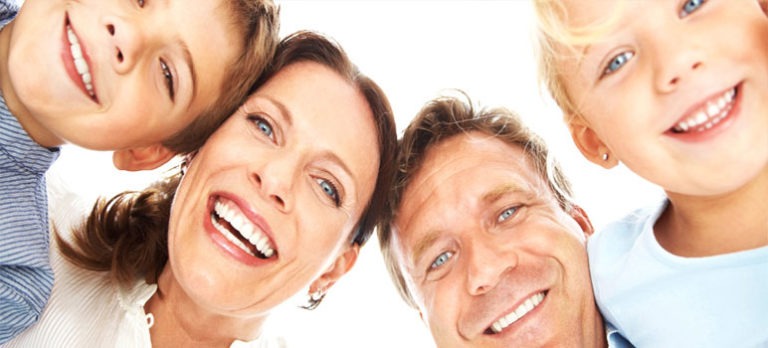 Picture of family smiling with clean white teeth